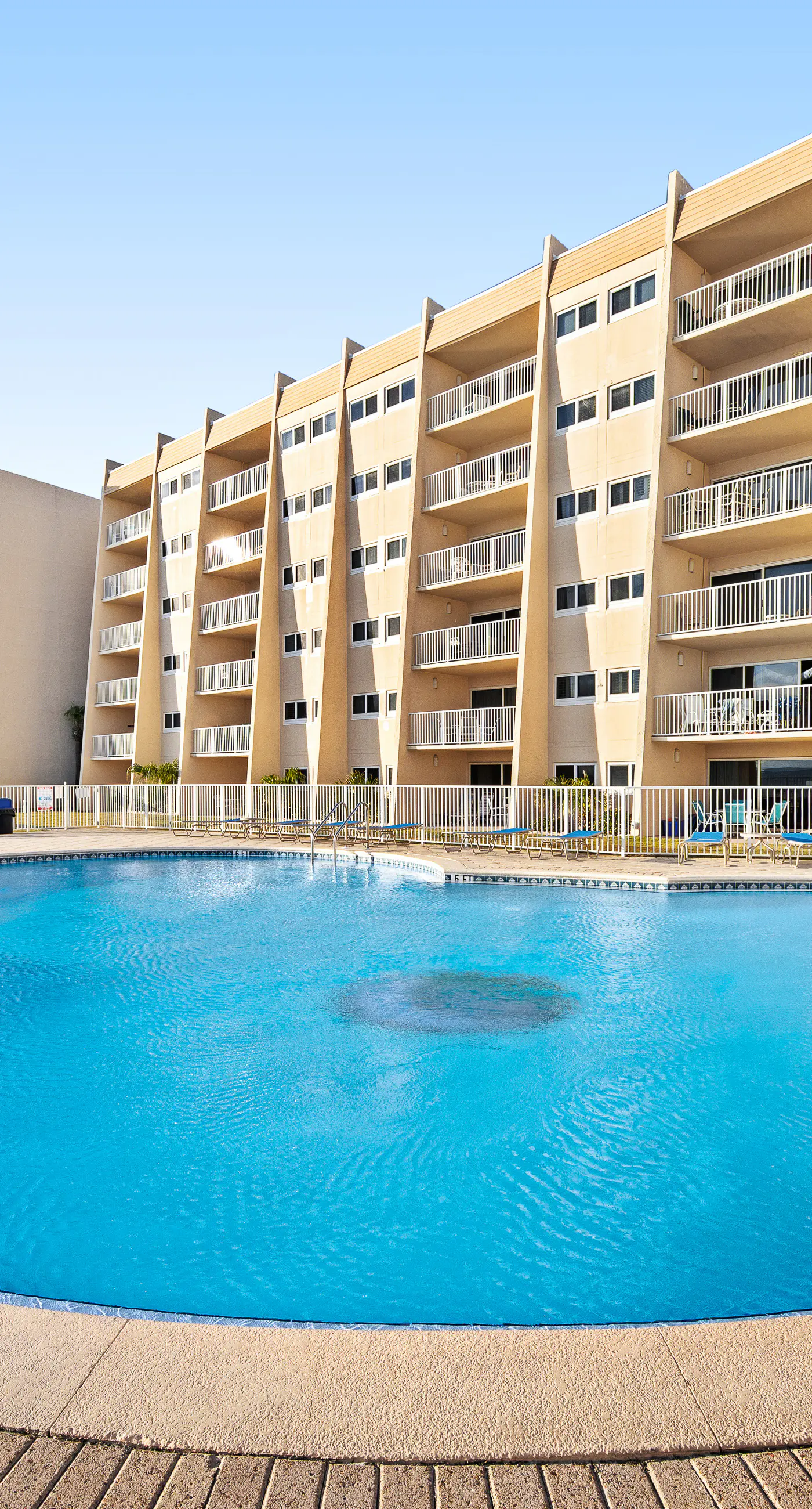 Ground floor oceanfront beachy condo with furnished patio, outdoor pool, gym