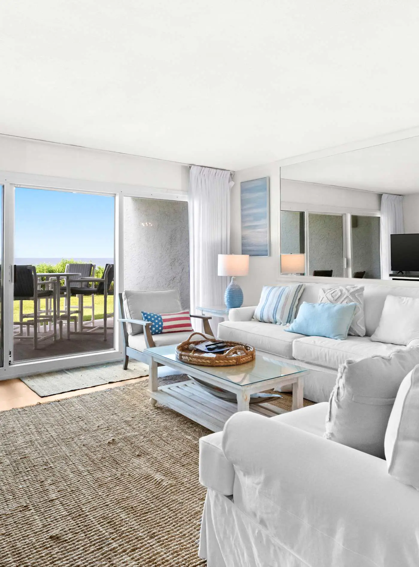 Ground floor oceanfront beachy condo with furnished patio, outdoor pool, gym