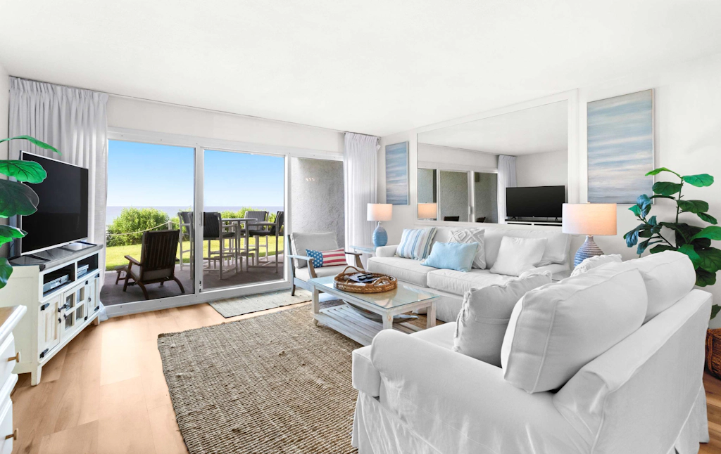 Ground floor oceanfront beachy condo with furnished patio, outdoor pool, gym