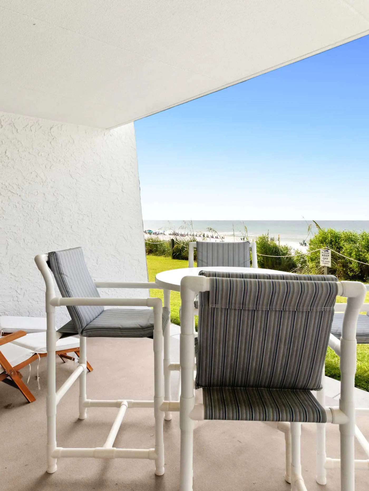 Ground floor oceanfront beachy condo with furnished patio, outdoor pool, gym