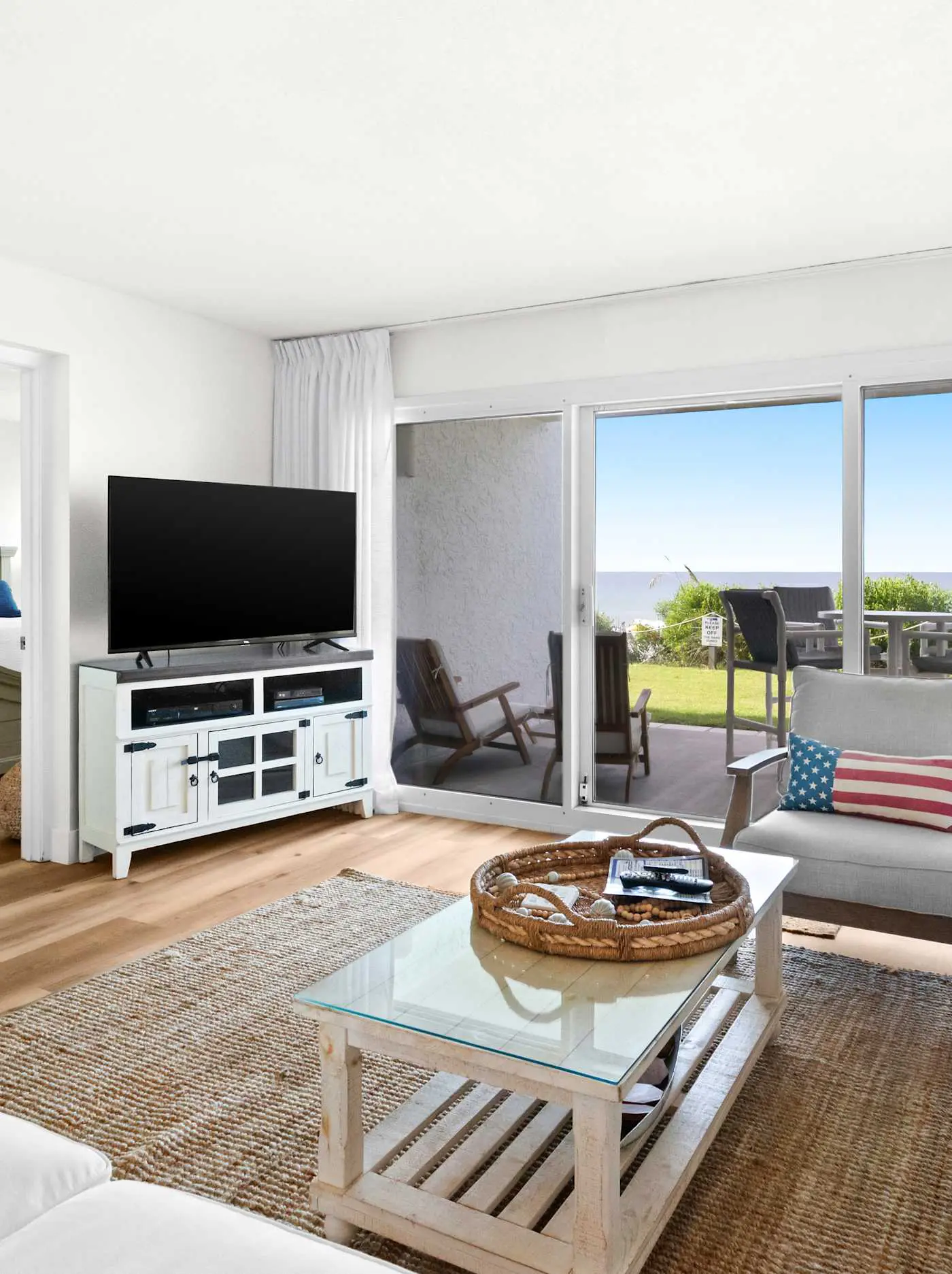 Ground floor oceanfront beachy condo with furnished patio, outdoor pool, gym