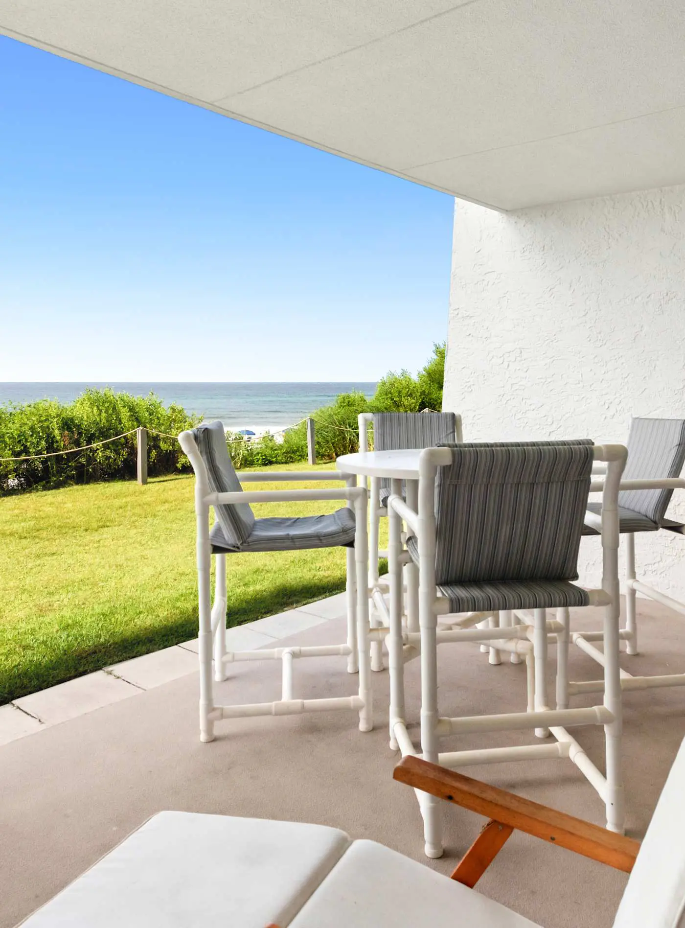 Ground floor oceanfront beachy condo with furnished patio, outdoor pool, gym