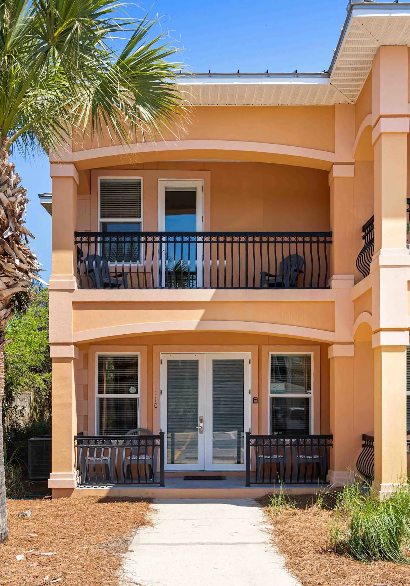 Elegant townhome with balconies, patio, pool & private beach access