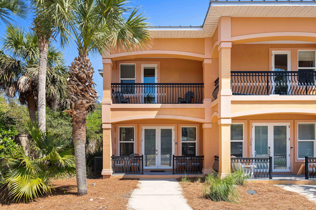 Elegant townhome with balconies, patio, pool & private beach access