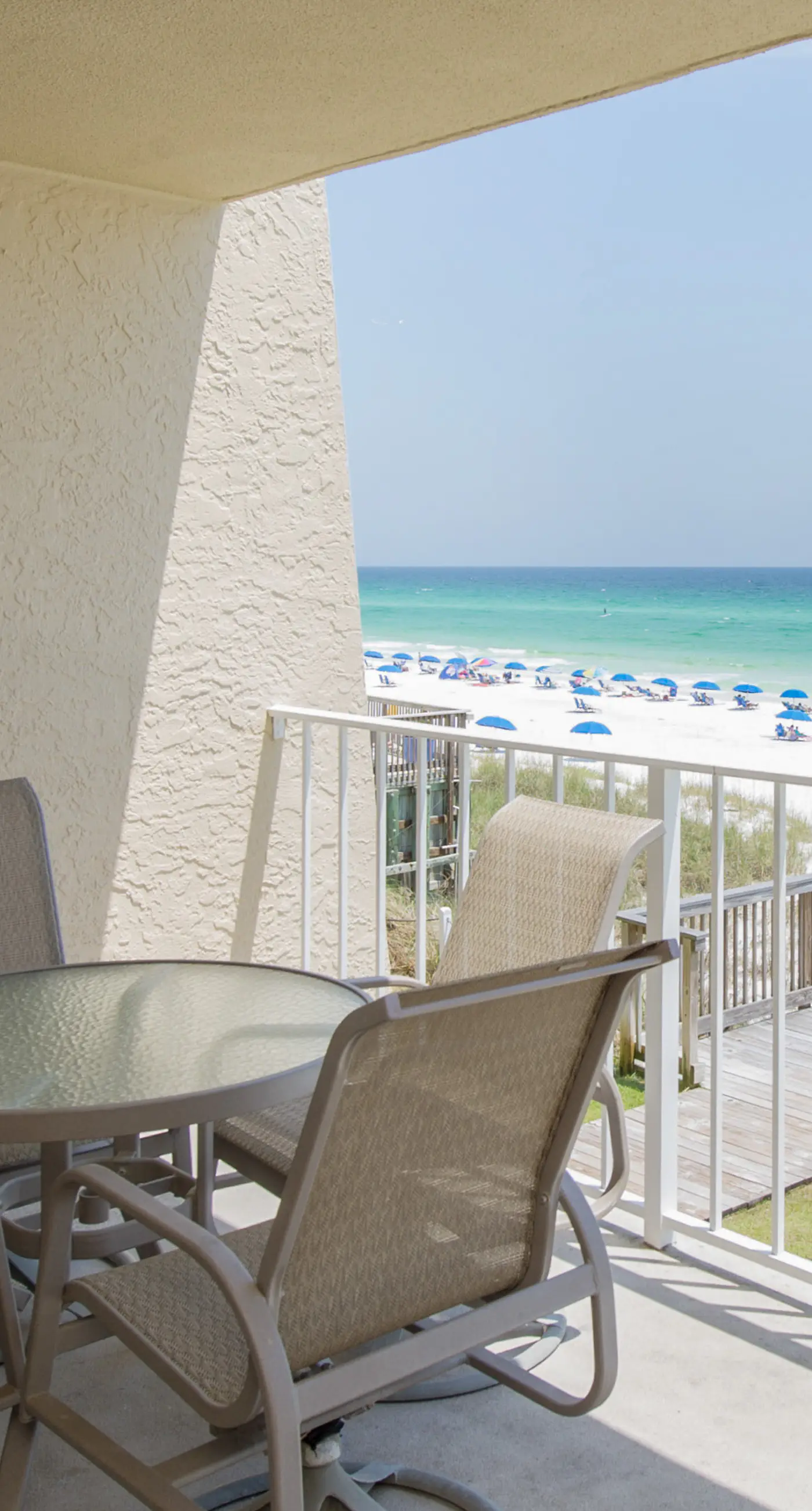 Spacious beachfront condo on second floor with balcony, beach views & pool