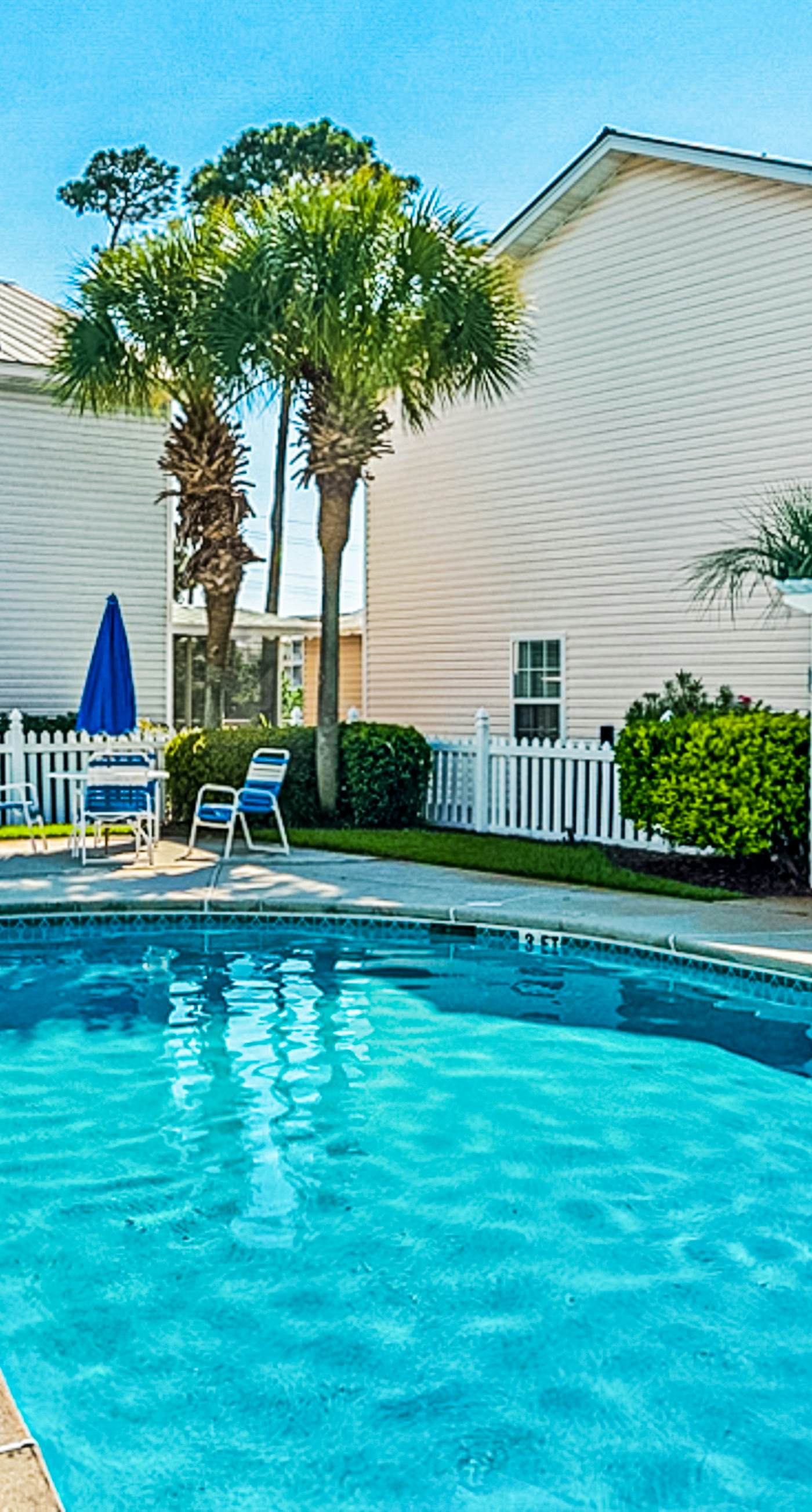 Dog-friendly townhouse near the beach with outdoor pool, water views, & AC
