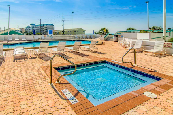 Cozy coastal condo with balcony, beach views, & resort pool