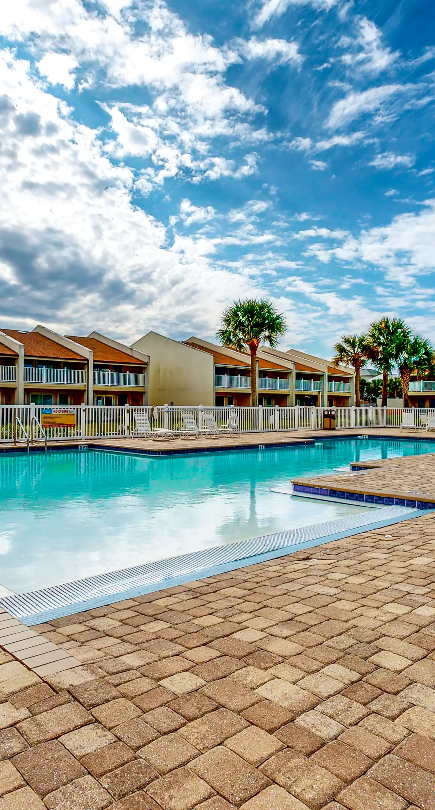 Ground-floor beach condo w/ a full kitchen, shared saltwater pool, & playground