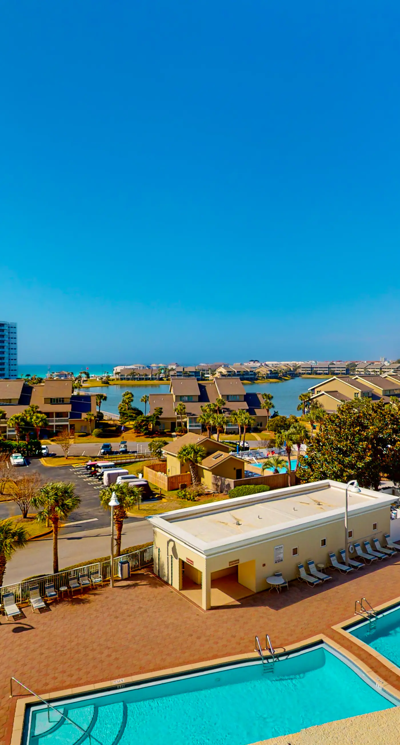 Fifth-floor condo with furnished balcony, beach access & views, shared pool & gym