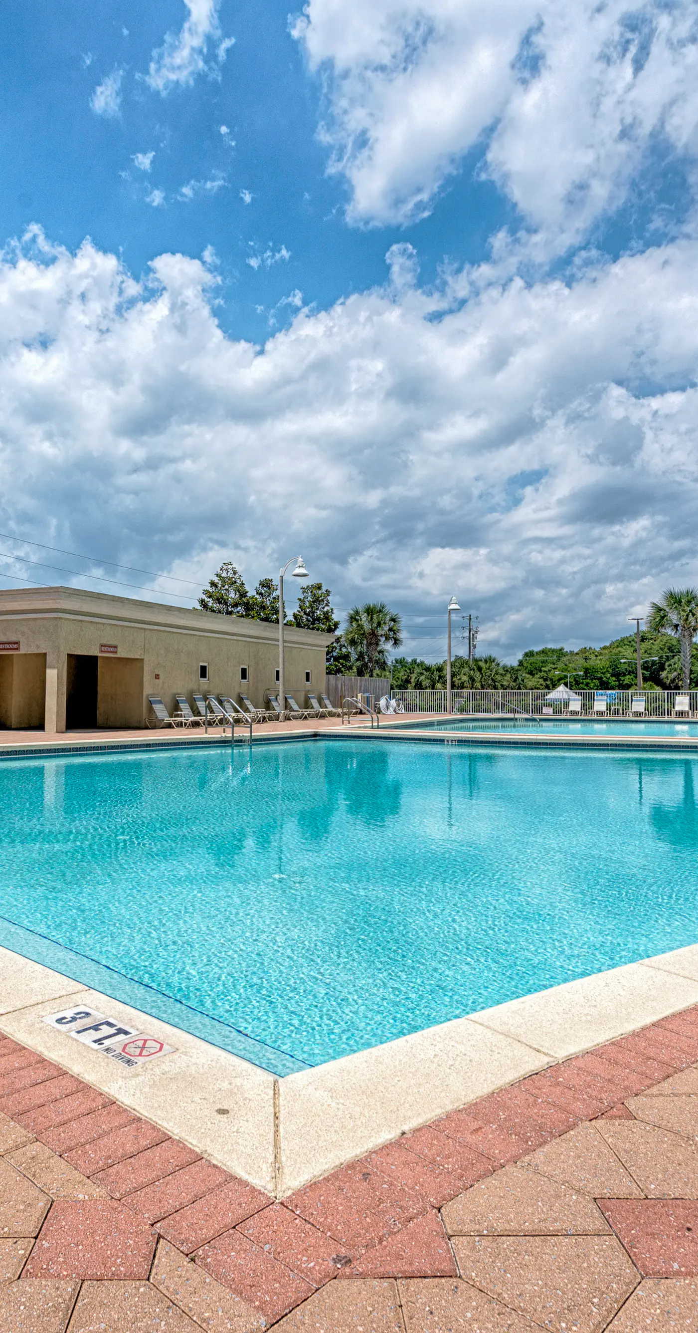 Fifth-floor condo with furnished balcony, beach access & views, shared pool & gym