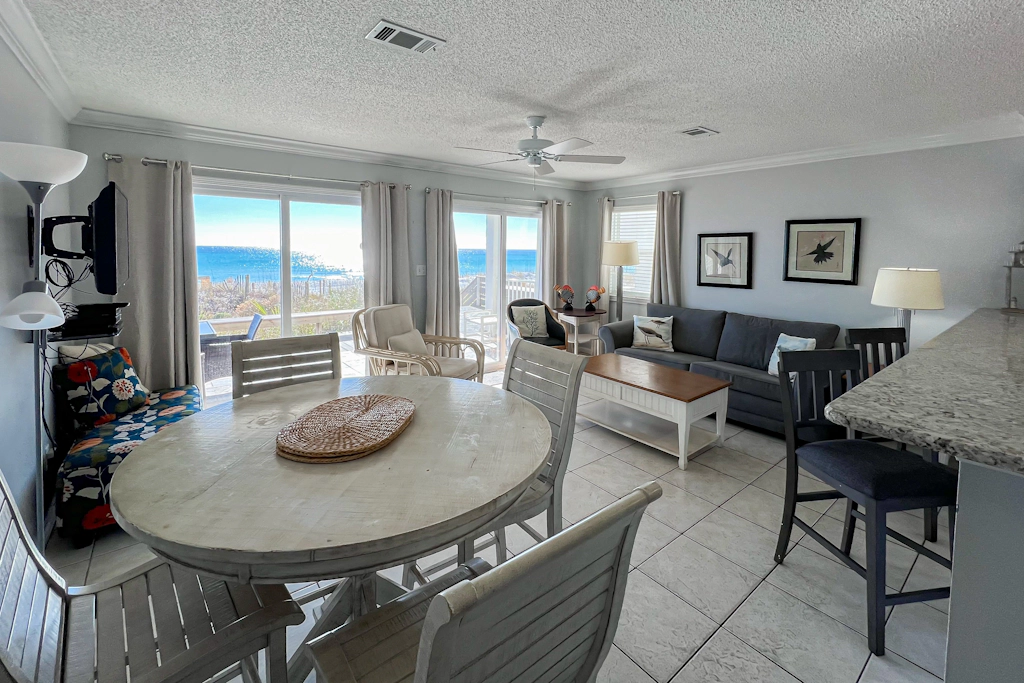 Lovely first floor condo with ocean views, patio, & grill - steps from the beach