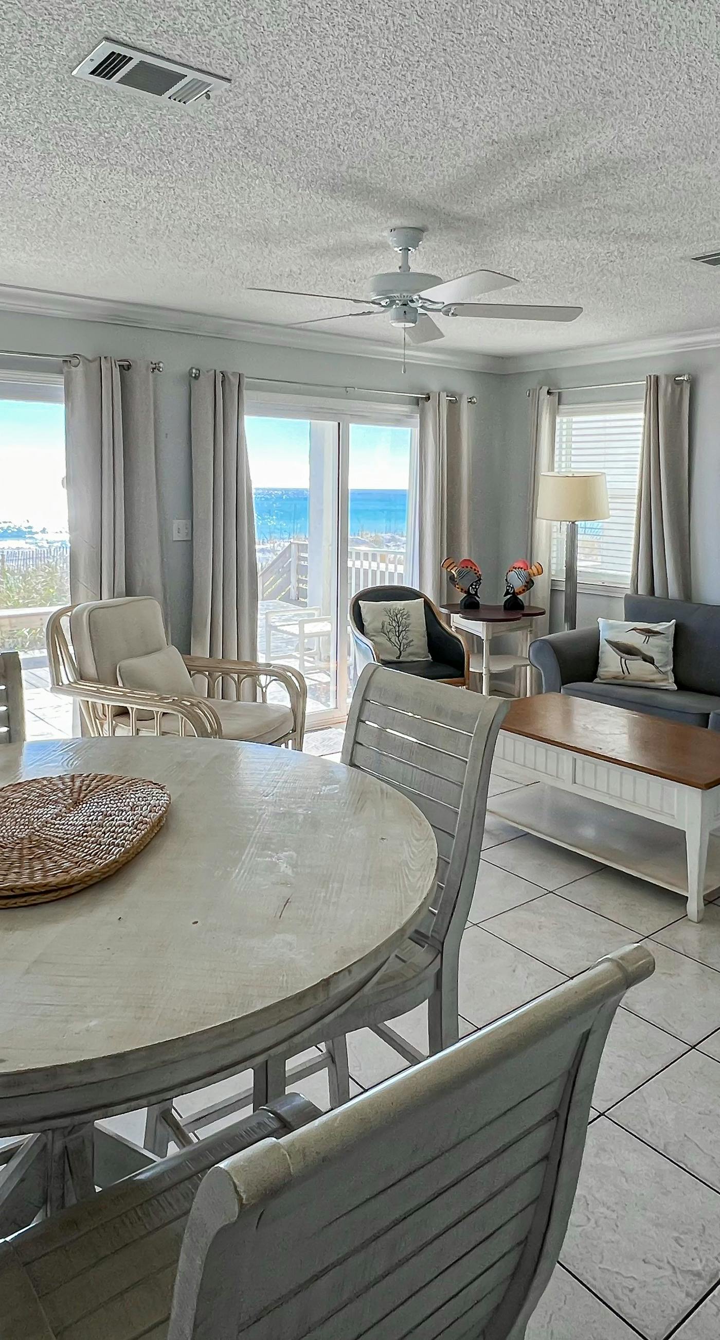 Lovely first floor condo with ocean views, patio, & grill - steps from the beach