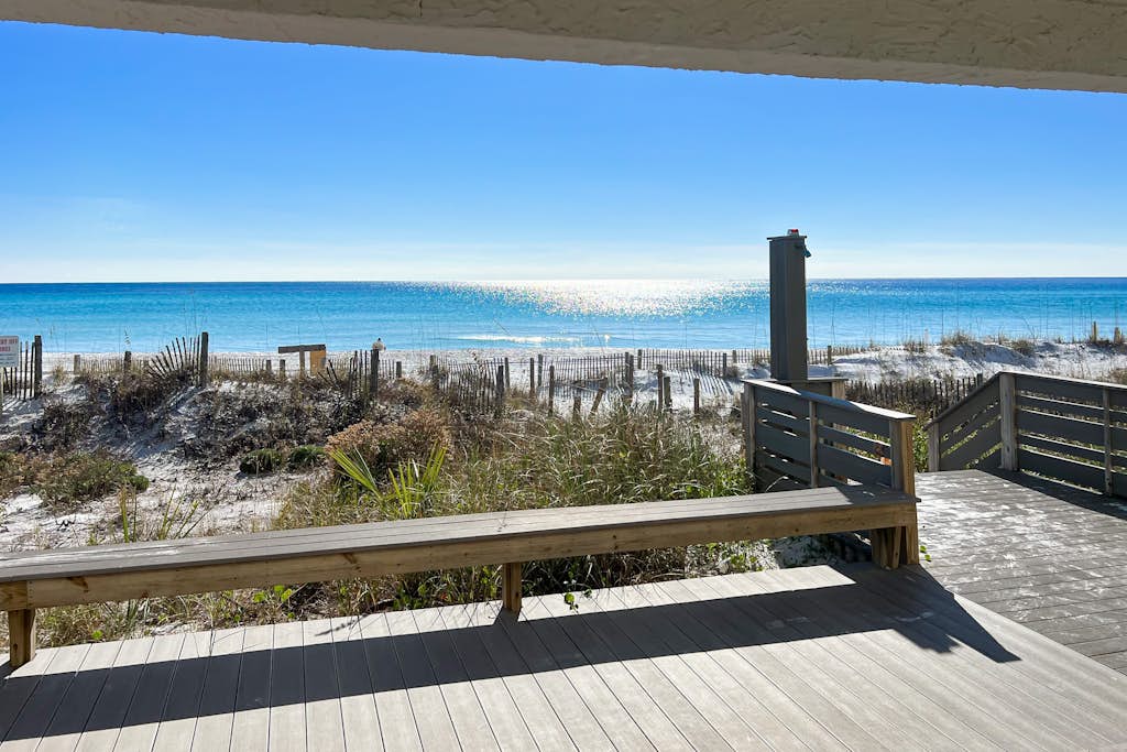 Lovely first floor condo with ocean views, patio, & grill - steps from the beach
