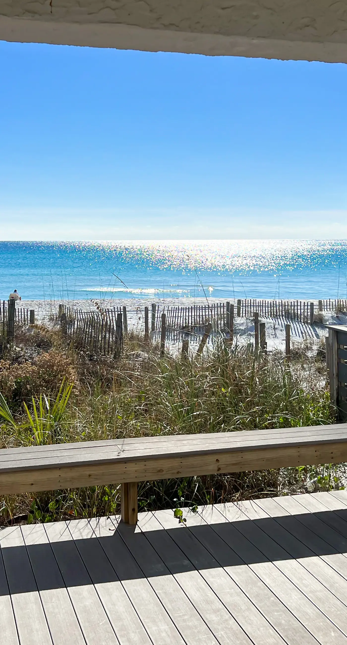 Lovely first floor condo with ocean views, patio, & grill - steps from the beach