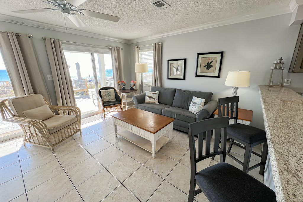 Lovely first floor condo with ocean views, patio, & grill - steps from the beach