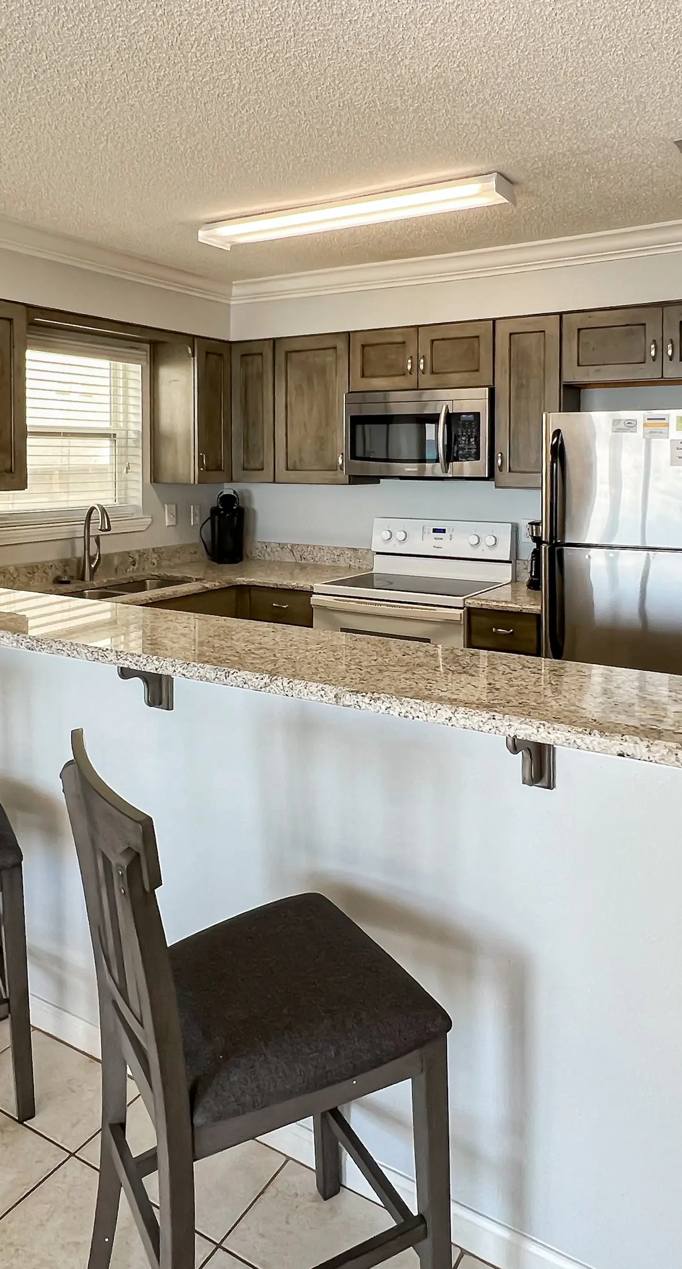 Lovely first floor condo with ocean views, patio, & grill - steps from the beach