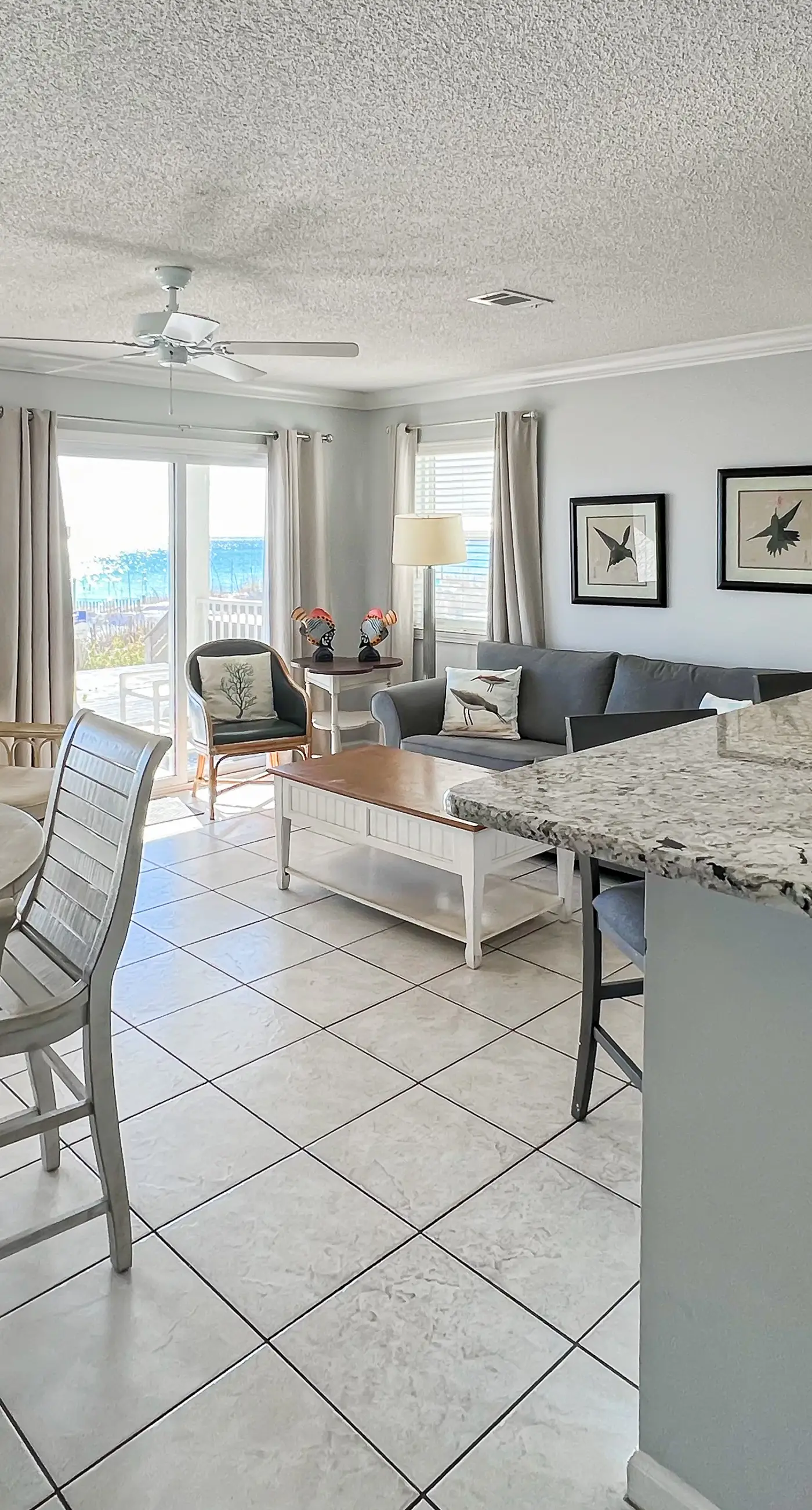 Lovely first floor condo with ocean views, patio, & grill - steps from the beach
