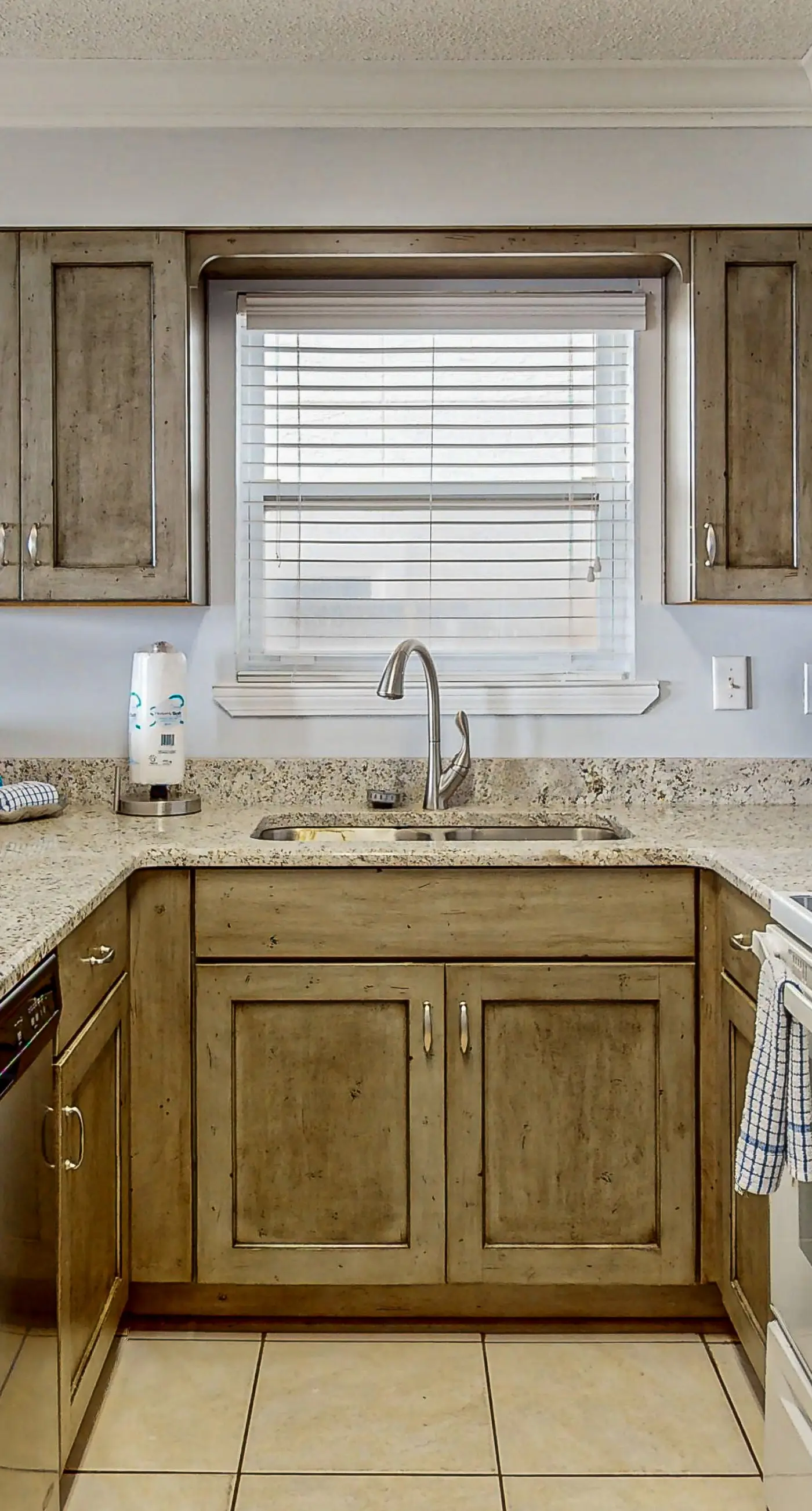 Lovely first floor condo with ocean views, patio, & grill - steps from the beach