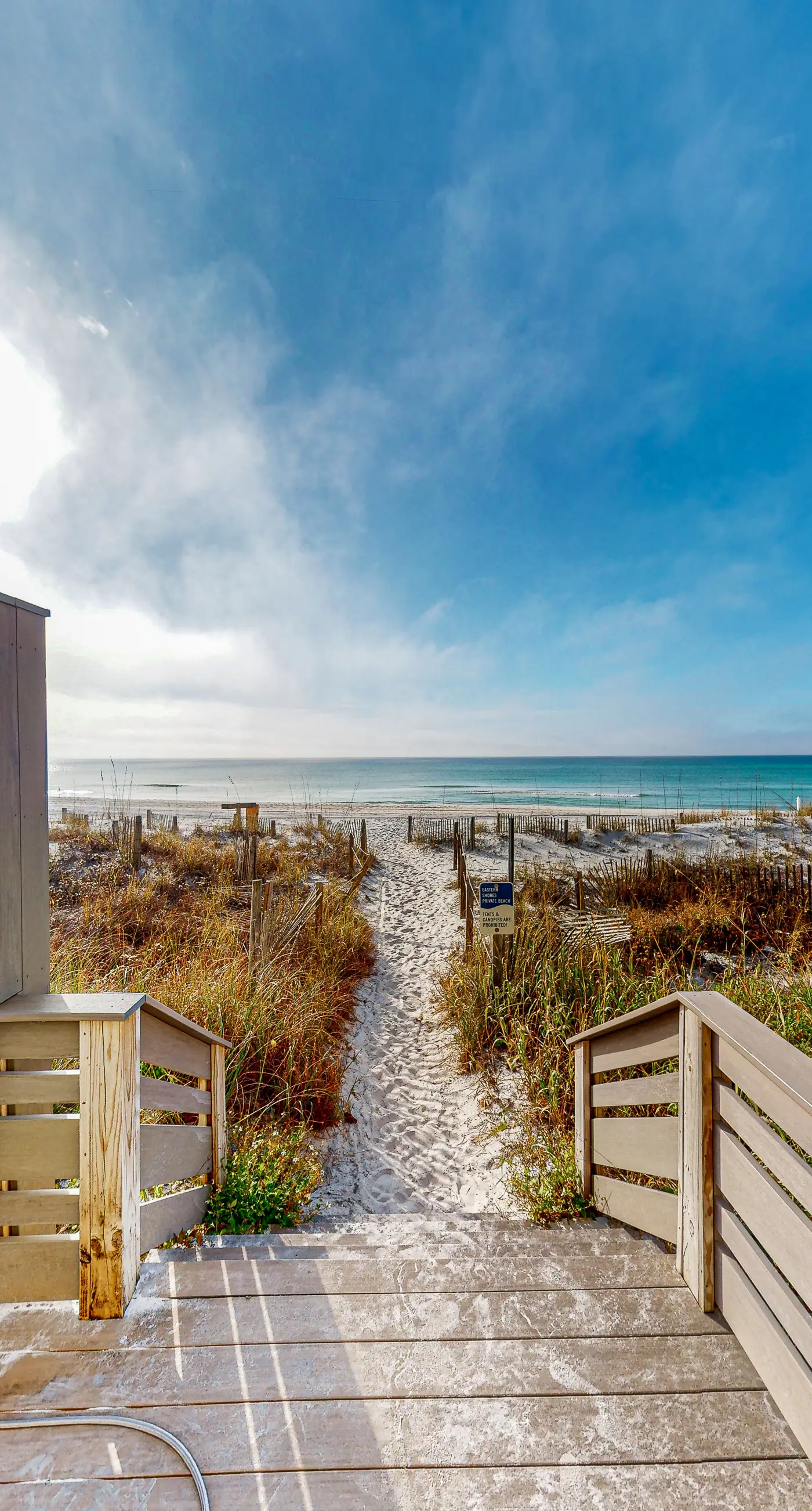 Lovely first floor condo with ocean views, patio, & grill - steps from the beach