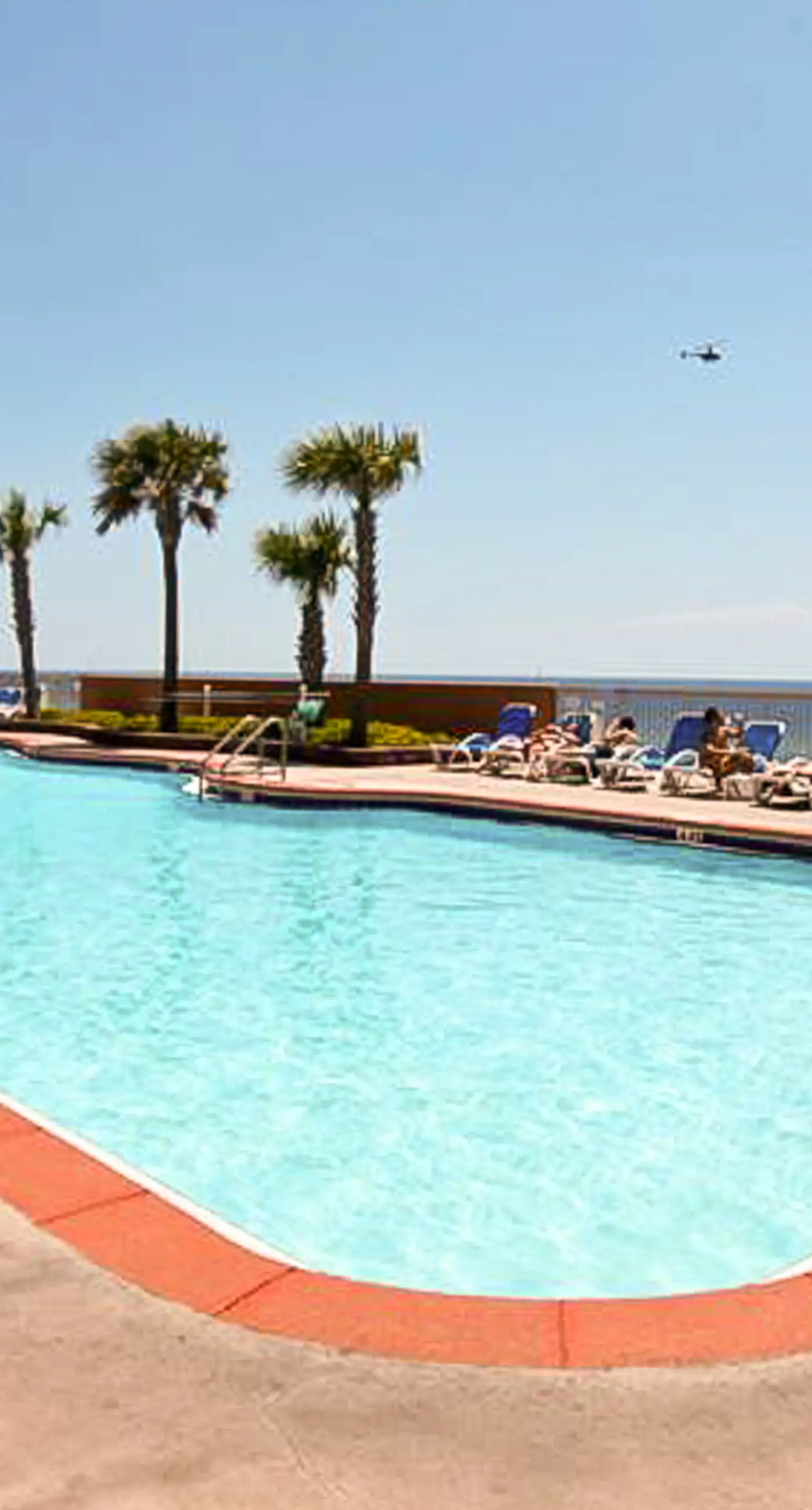 Tropical-themed 17th-floor condo with beachfront views, pools & gym