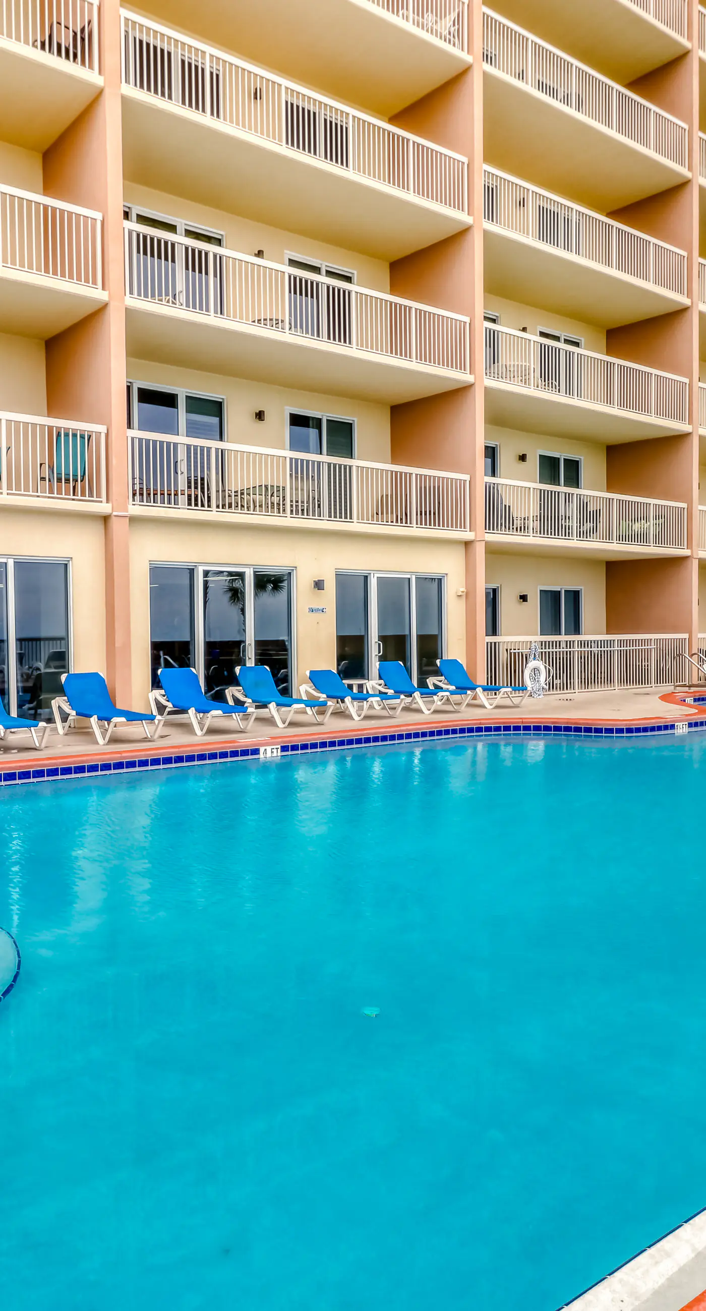 Elegant, beachfront condo with a furnished balcony, views & two pools