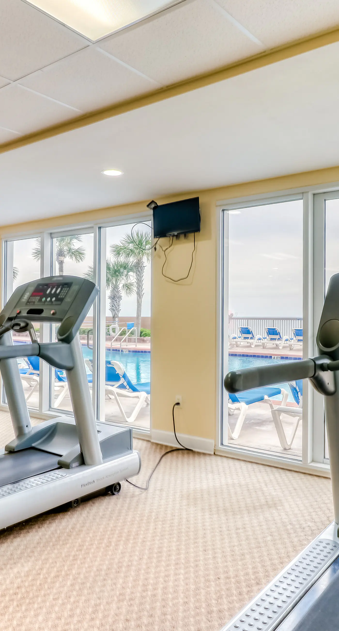 Elegant, beachfront condo with a furnished balcony, views & two pools