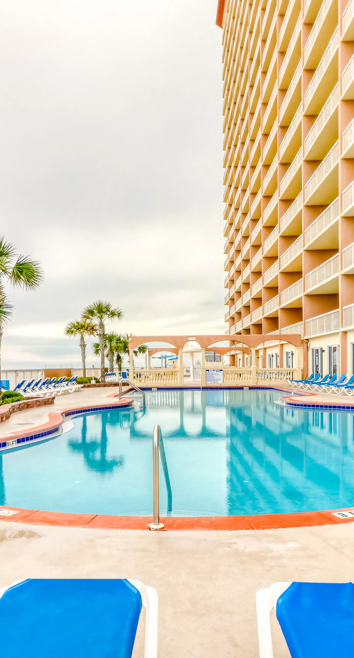 Elegant, beachfront condo with a furnished balcony, views & two pools