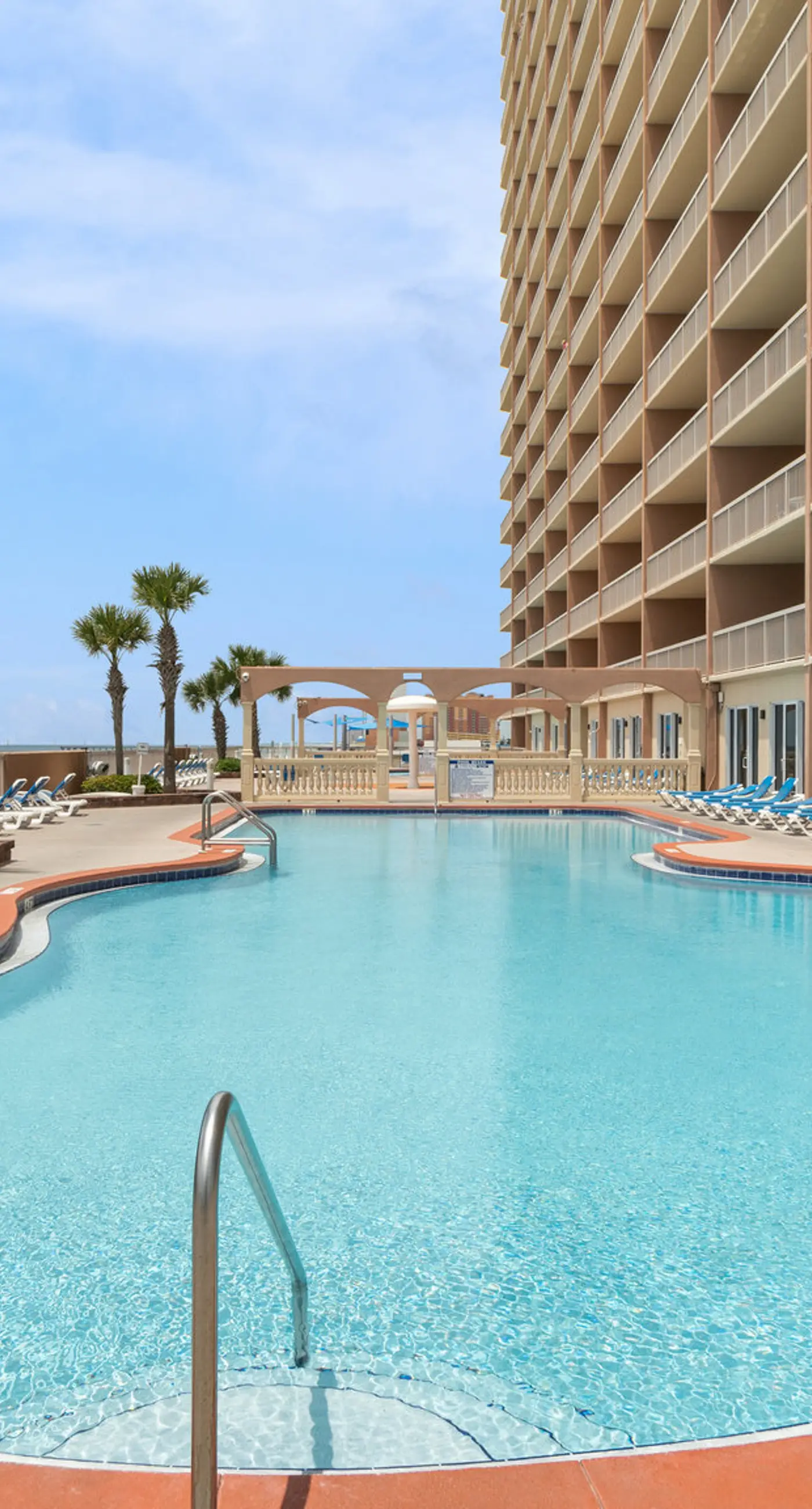 Elegant, beachfront condo with a furnished balcony, views & two pools