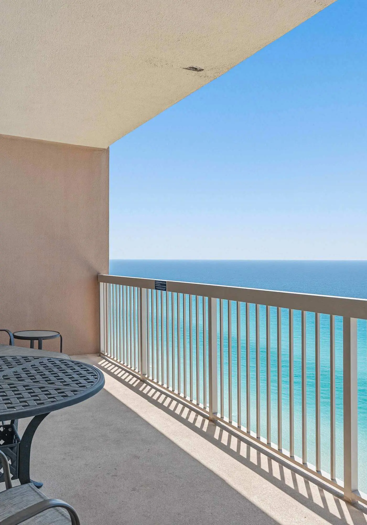 Elegant, beachfront condo with a furnished balcony, views & two pools