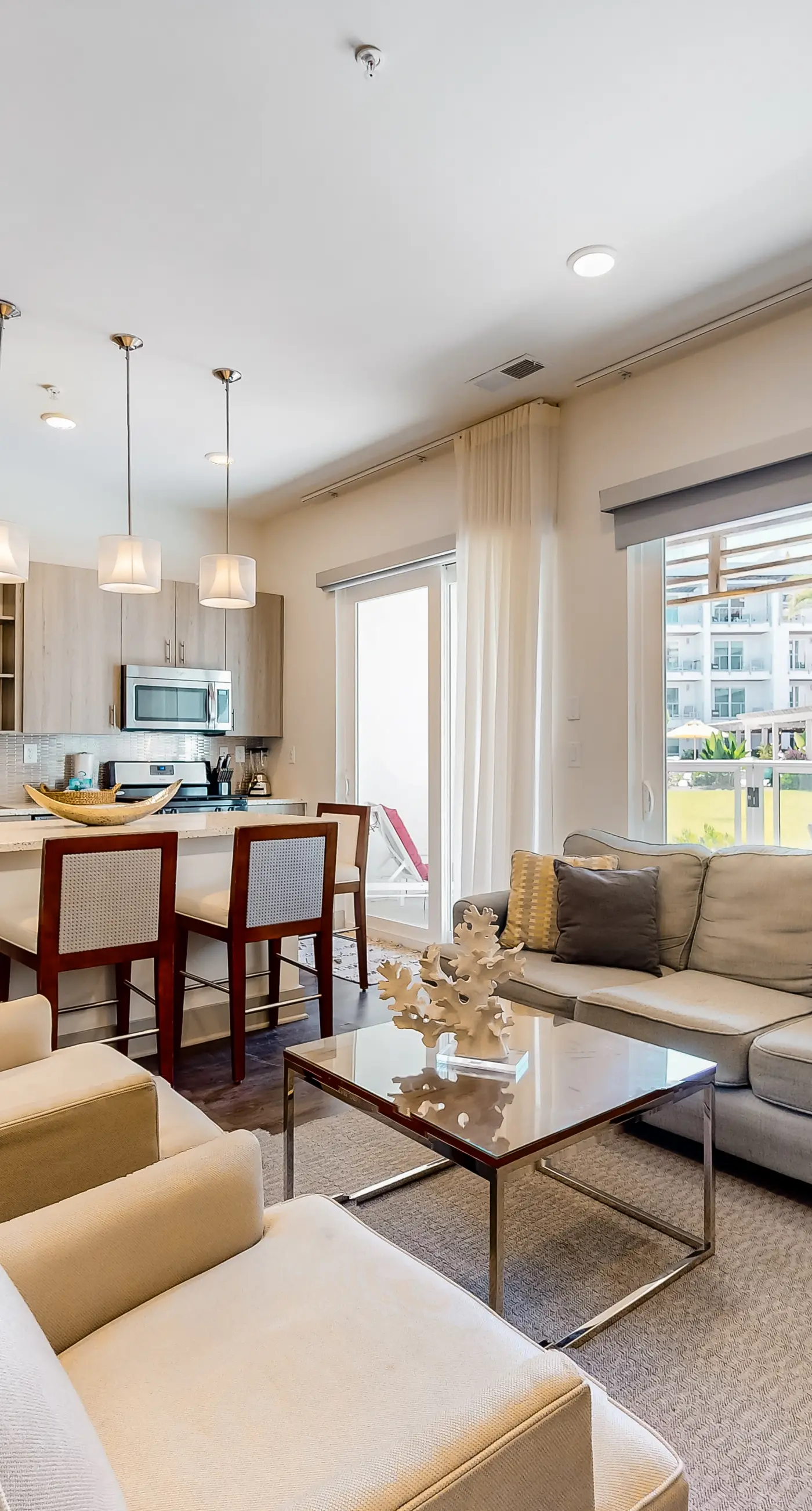 Chic condo steps from beach with patio, W/D, AC, and resort-style pool and gym