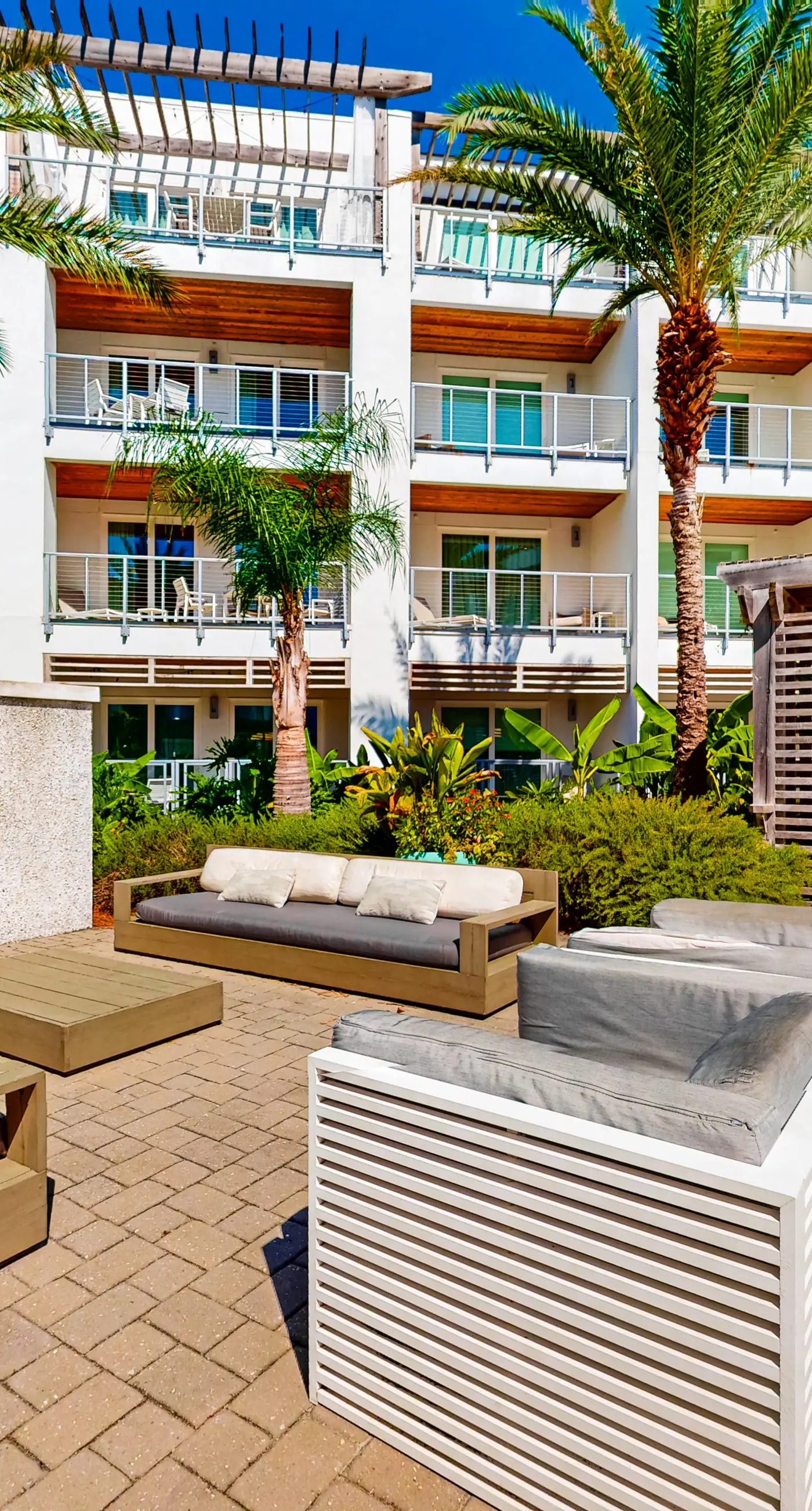 Chic condo steps from beach with patio, W/D, AC, and resort-style pool and gym
