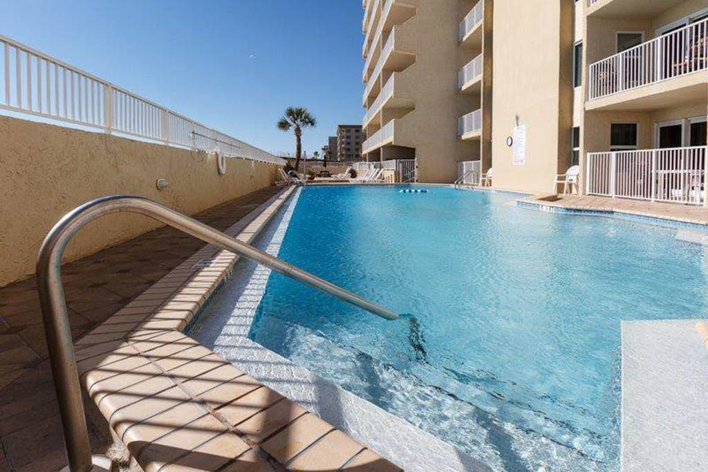 Gulf-front condo with views, beach access, pool, balcony, & fitness room