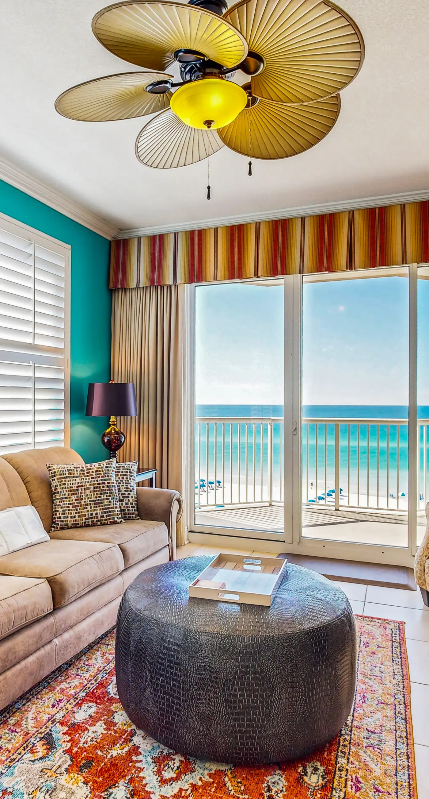 Beachfront condo with beach chairs, an umbrella, and a pool