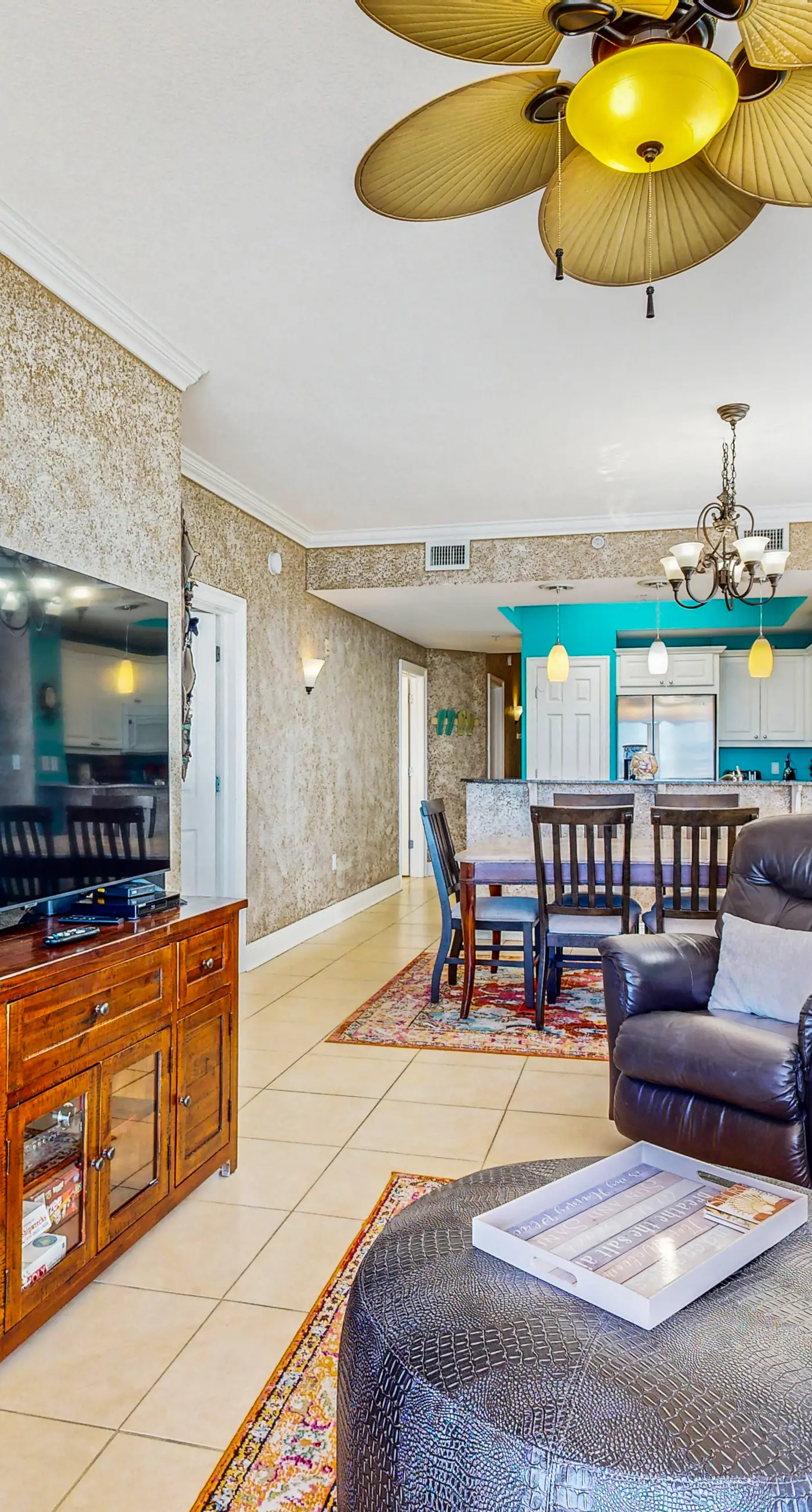 Beachfront condo with beach chairs, an umbrella, and a pool