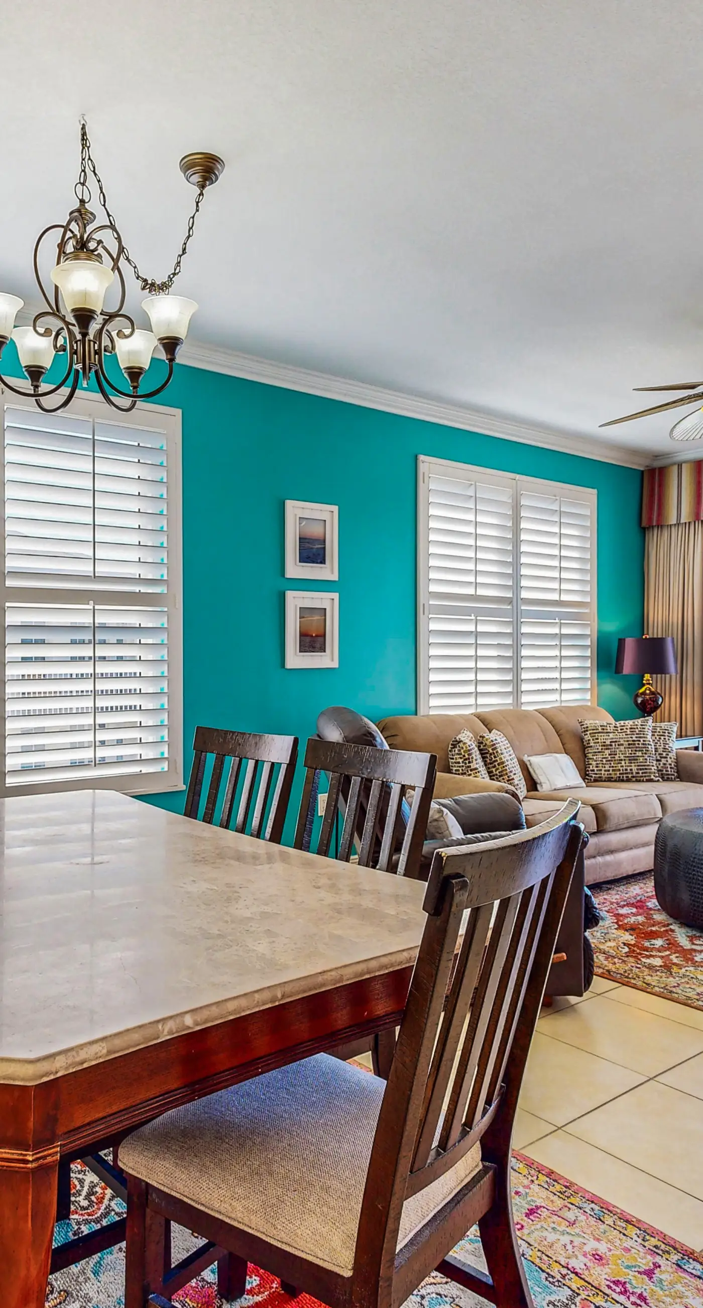 Beachfront condo with beach chairs, an umbrella, and a pool