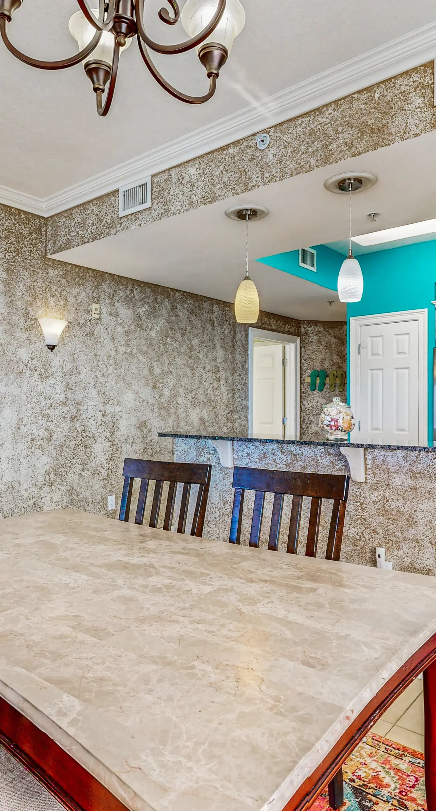 Beachfront condo with beach chairs, an umbrella, and a pool
