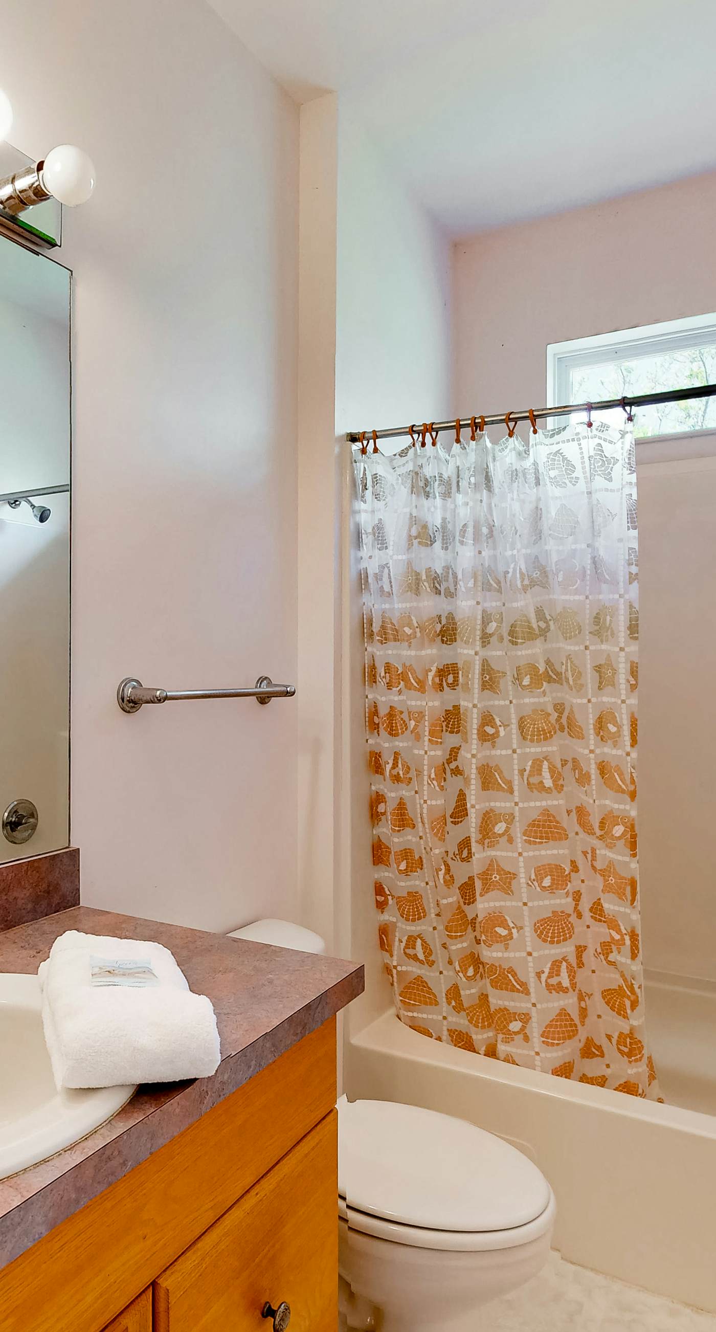 Snowbird-friendly home near the beach with deck, outdoor shower, W/D