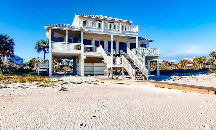 Beachfront home with a porch, washer/dryer, outdoor shower, & AC