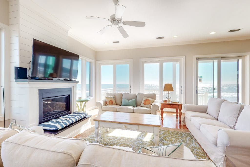 Beachfront home with a porch, washer/dryer, outdoor shower, & AC