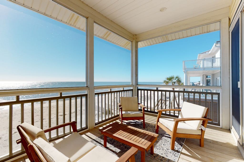 Beachfront home with a porch, washer/dryer, outdoor shower, & AC