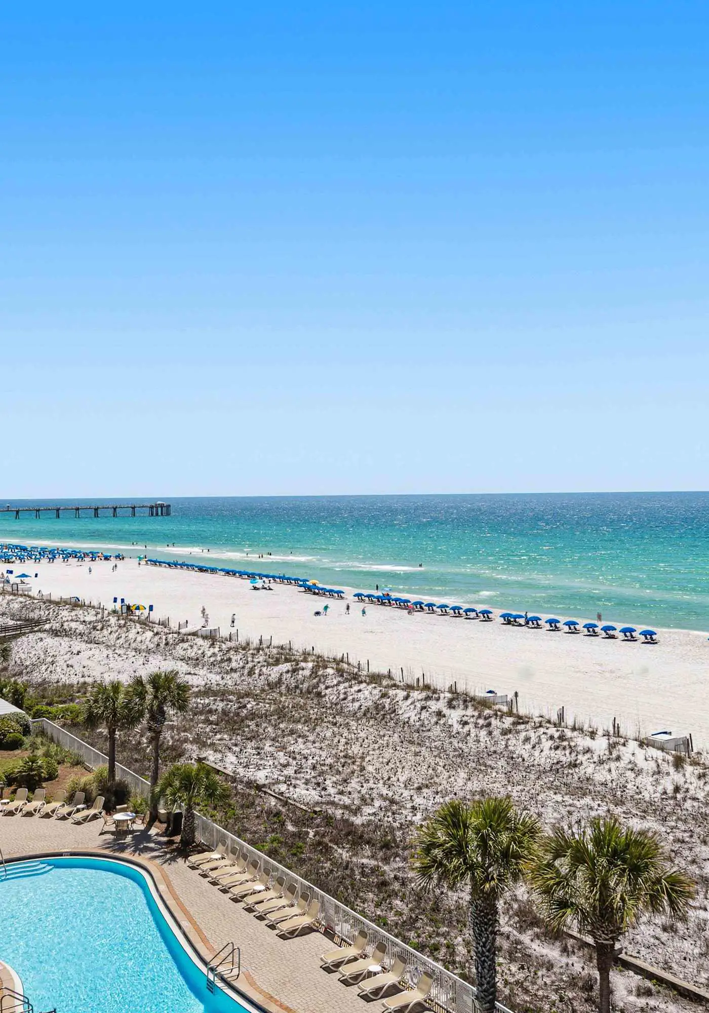 Enchanting oceanfront condo with pool, balcony, fitness area, & washer&dryer