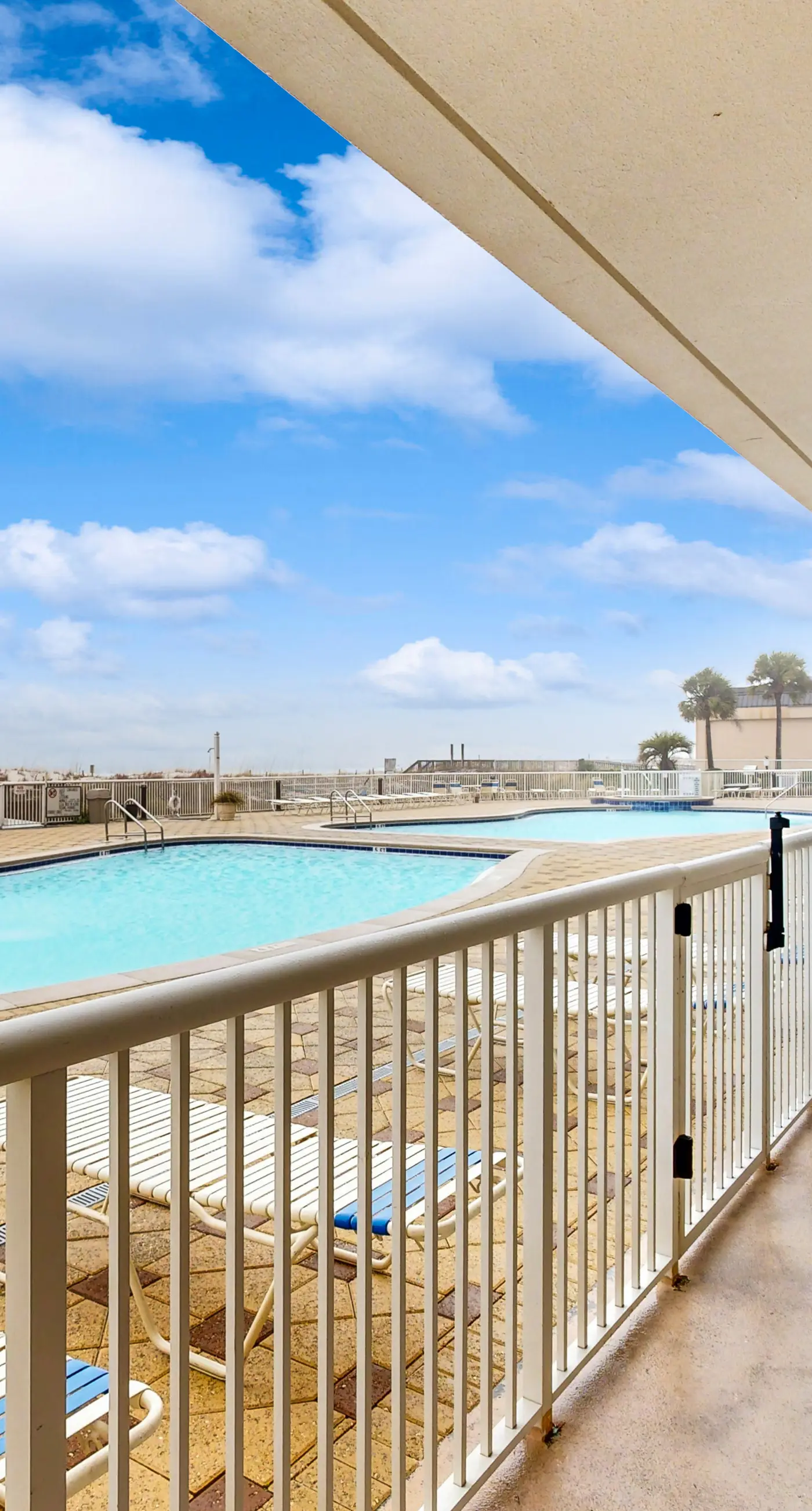 Gulf-front condo with washer/dryer, pools, hot tub, fitness room, & beach access