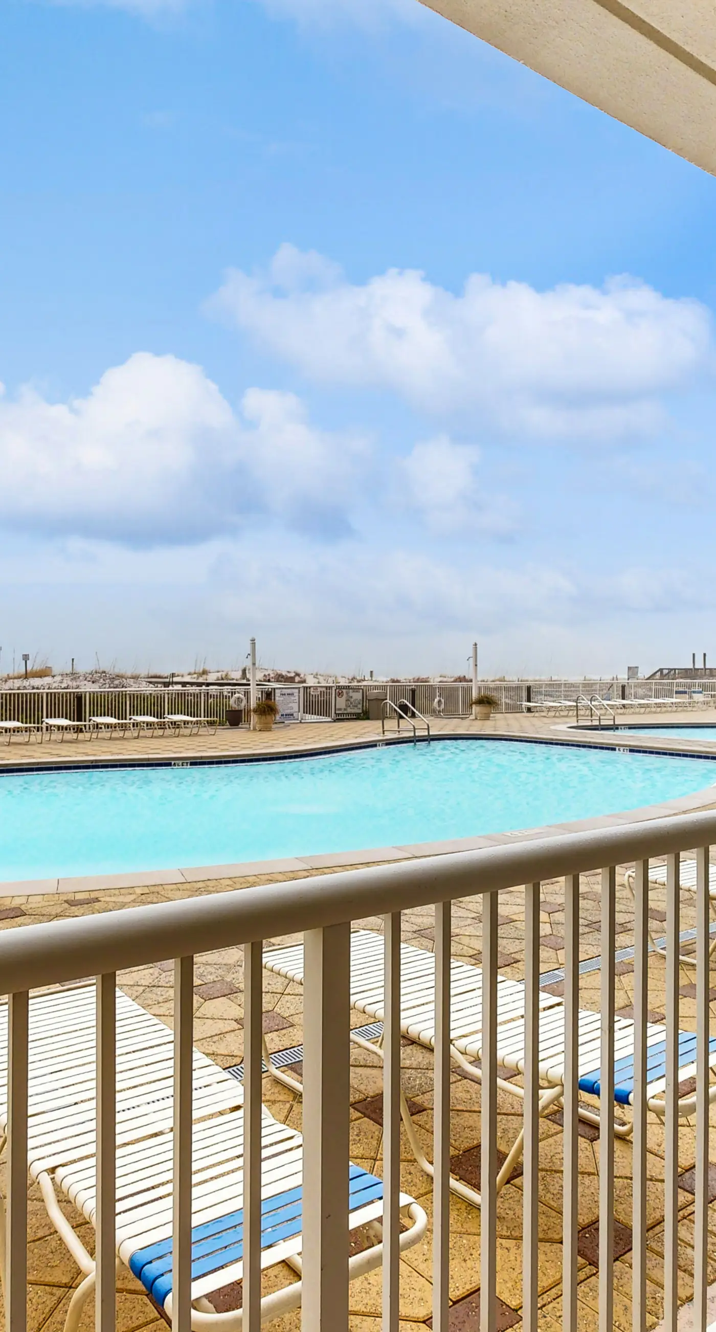 Gulf-front condo with washer/dryer, pools, hot tub, fitness room, & beach access