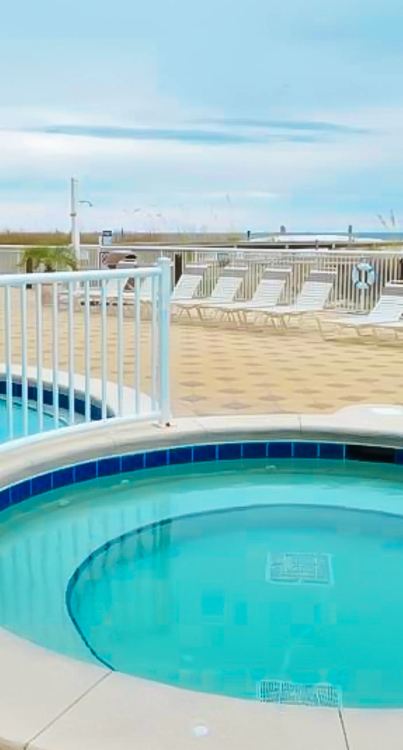 Gulf-front condo with washer/dryer, pools, hot tub, fitness room, & beach access