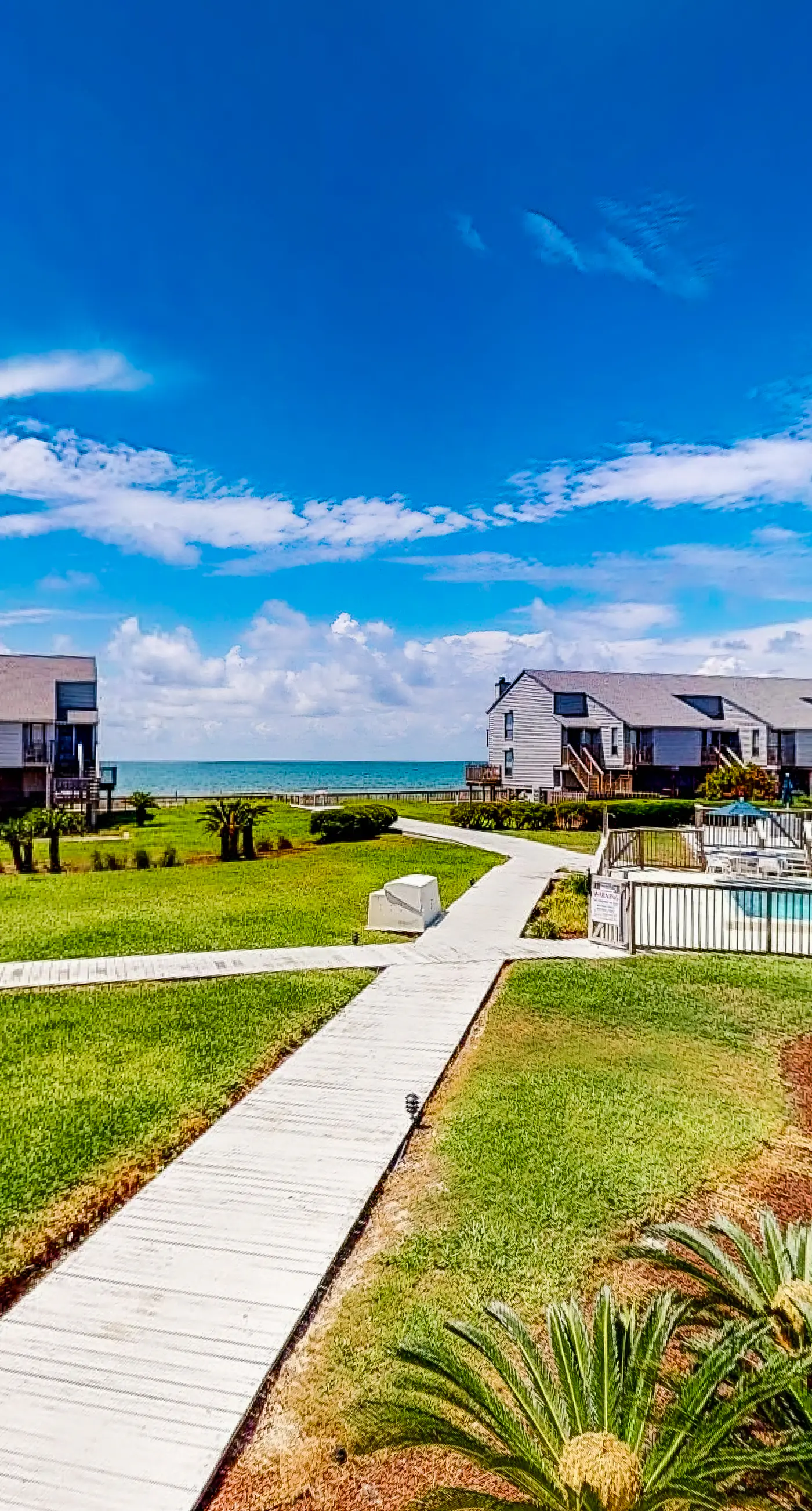 Poolside dog-friendly townhouse with partial Gulf views, on-site pool & grills