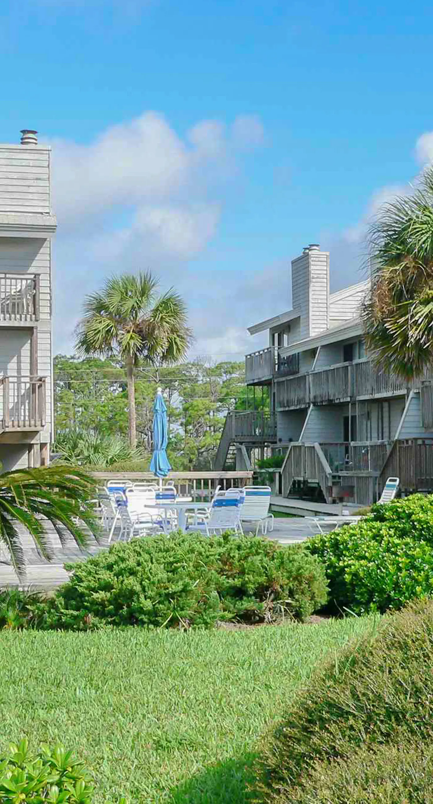 Beachfront East End townhouse with beach views, deck, on-site pool & grills
