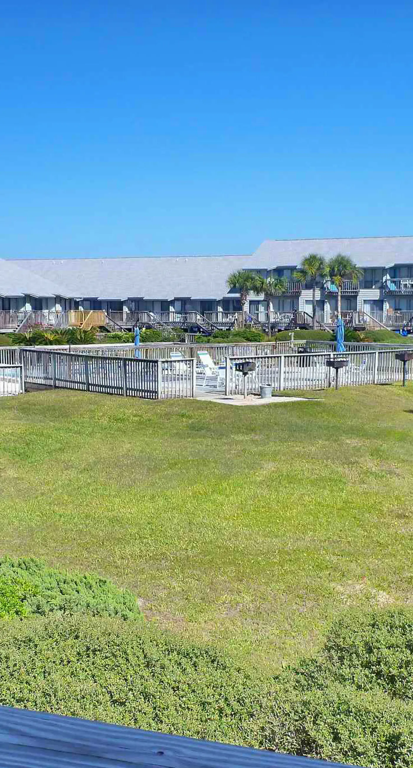 Beachfront East End townhouse with beach views, deck, on-site pool & grills