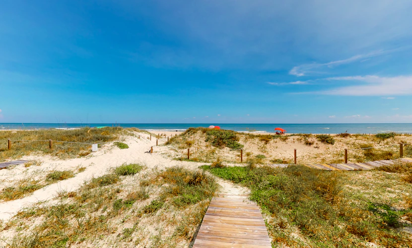 Dog-friendly beachfront home with private boardwalk, park style grill, deck, beach view