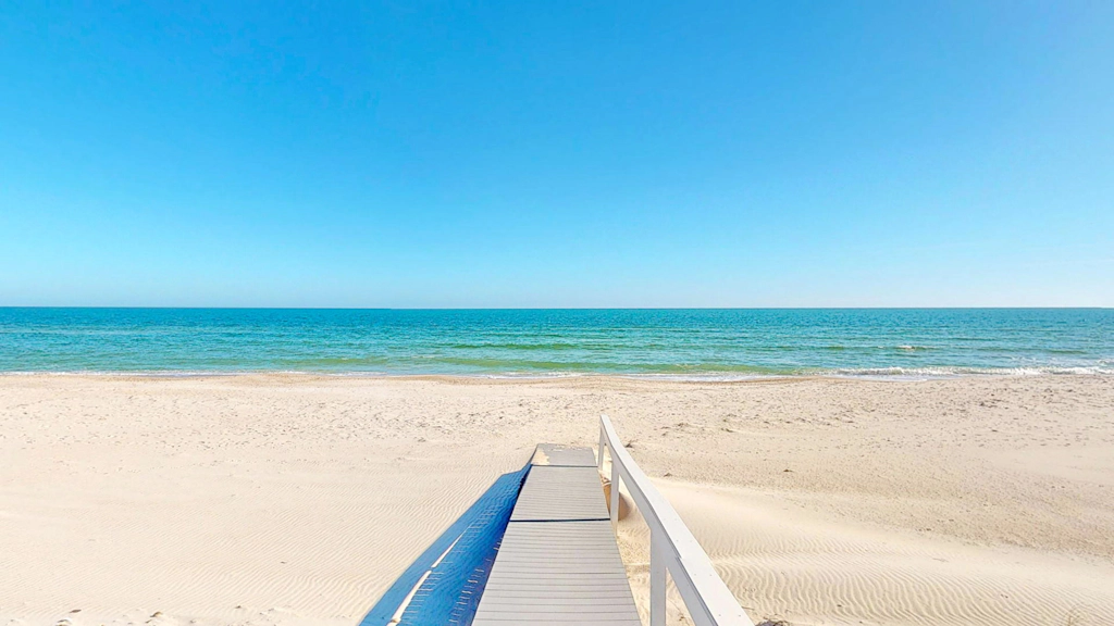 Upscale beachfront home with private hot tub, grill, on-site pools, gym, dogs OK