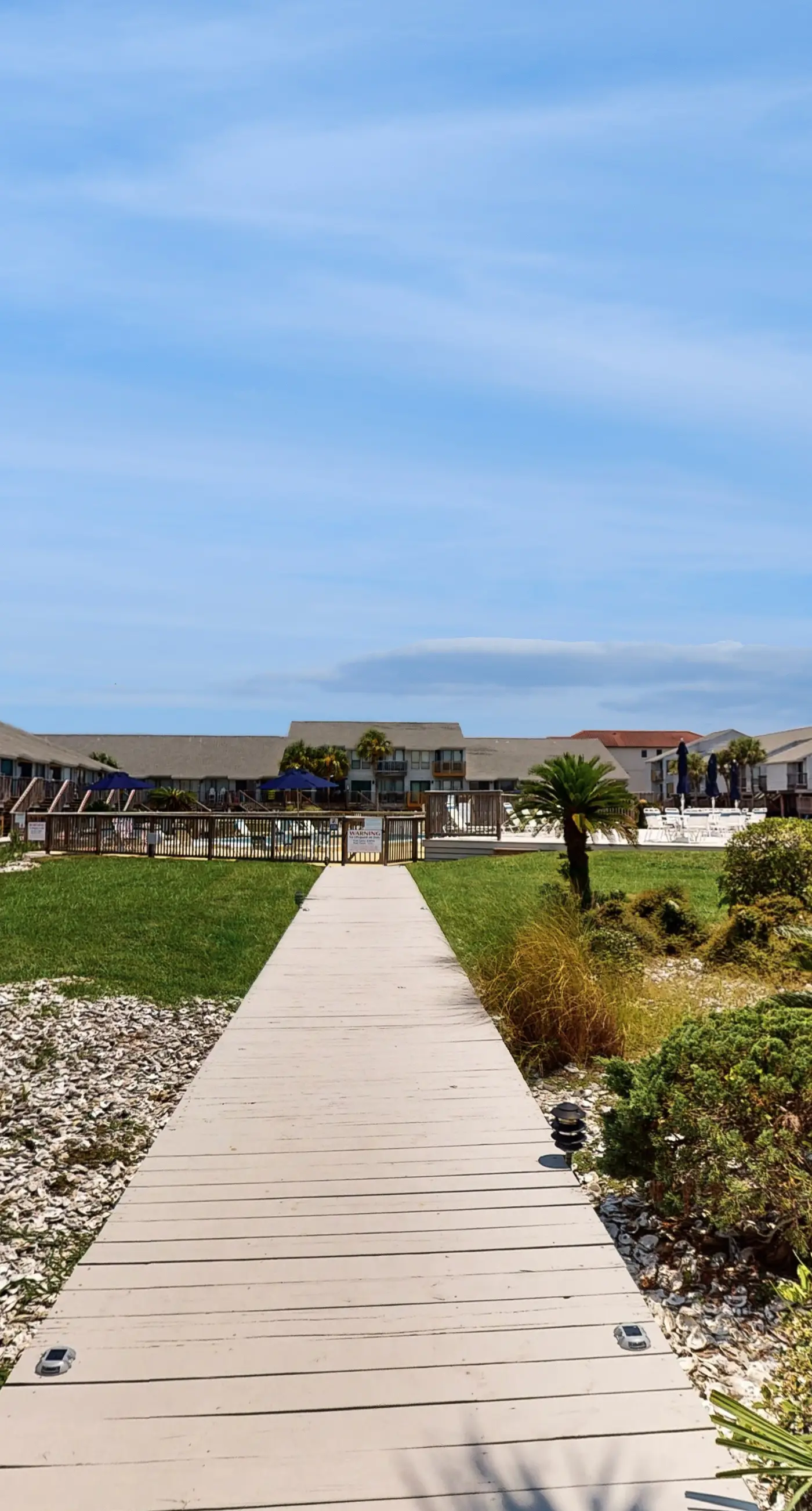 Comfortable townhome steps from beach with pool access, balcony, & W/D